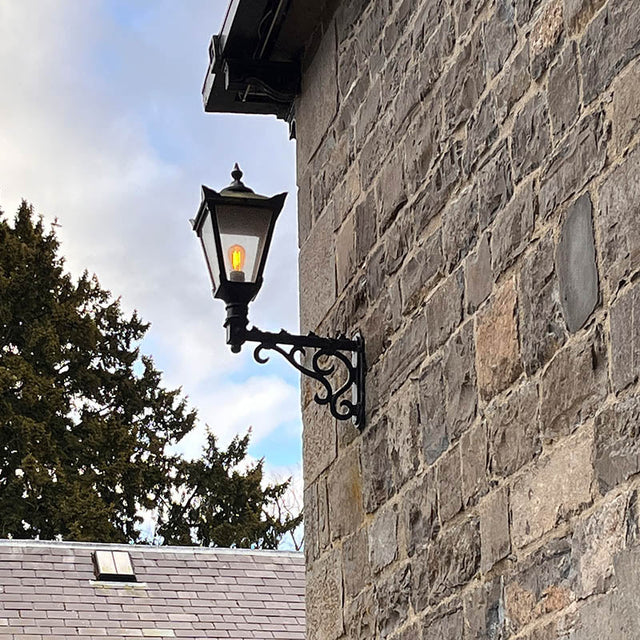 Victorian traditional cast iron wall light with decorative arm