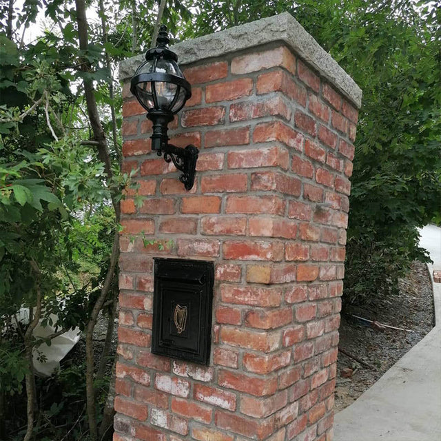 Victorian globe wall light in cast iron with decorative arm