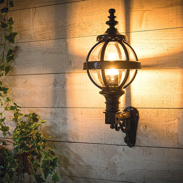 Victorian globe wall light in cast iron with decorative arm