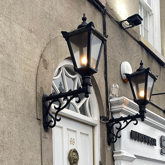 Victorian traditional cast iron wall light with decorative arm