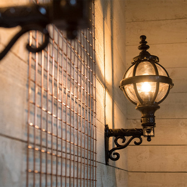 Victorian globe wall light in cast iron with decorative arm